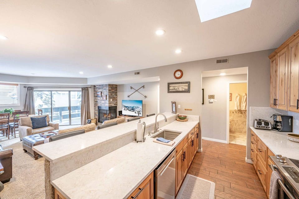 Full kitchen with additional seating for 3 at the breakfast bar  - Refrigerator, oven, stove, dishwasher, microwave, and coffee maker.