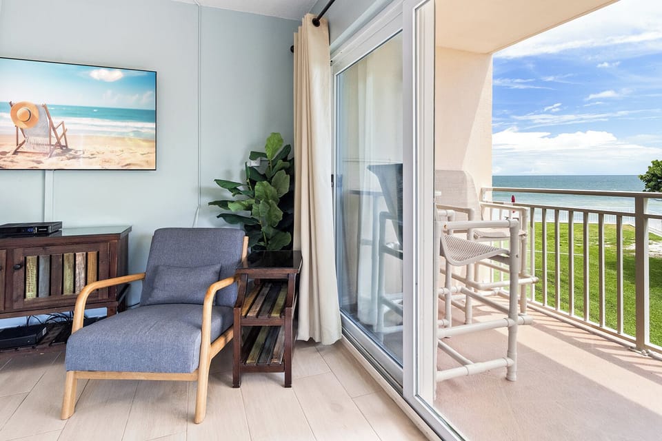 A bright and welcoming space with plush seating, natural light, and access to a private balcony