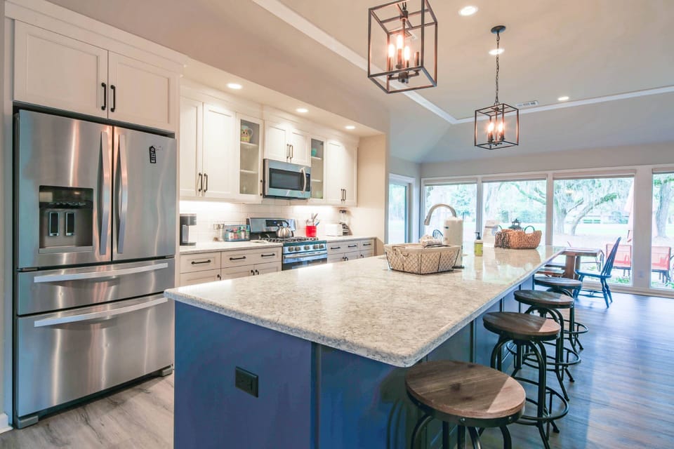 There is plenty of room to prepare your vacation feasts in this large kitchen with a central island.