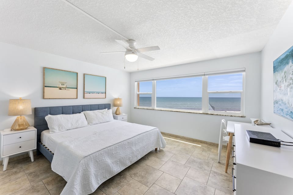 A peaceful master bedroom with a plush king-size bed and stunning sea views.