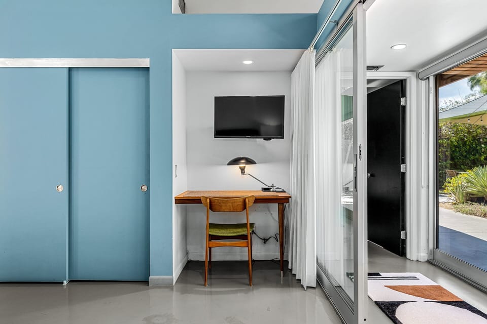 Built in desk in with TV mounted to wall above