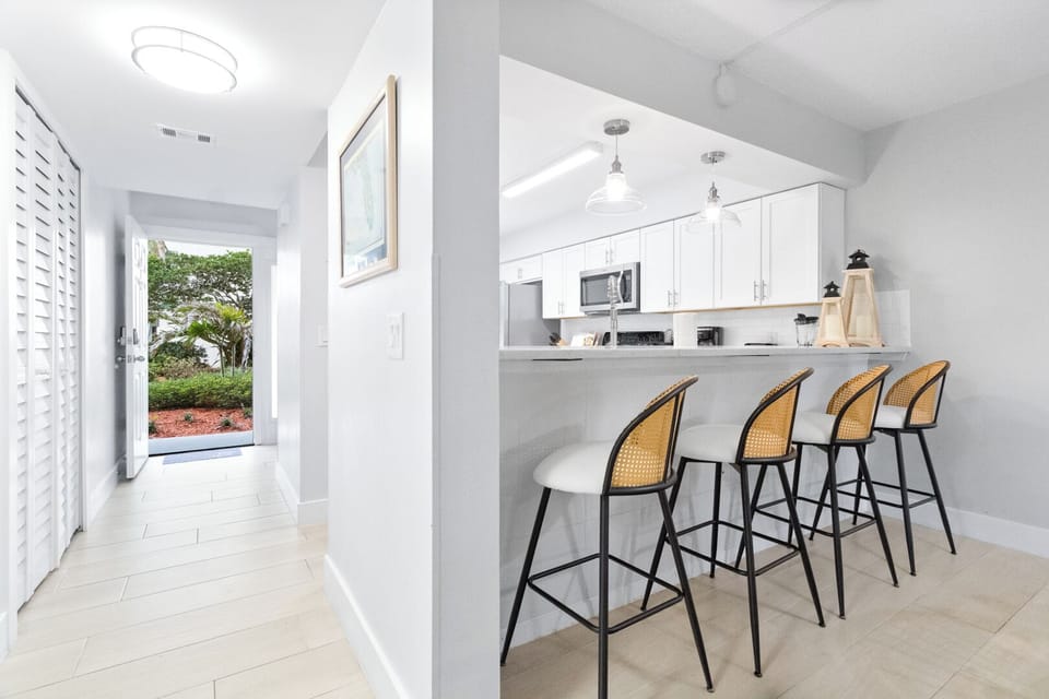 A casual breakfast bar with seating for four, perfect for morning coffee or a quick bite before heading to the beach.