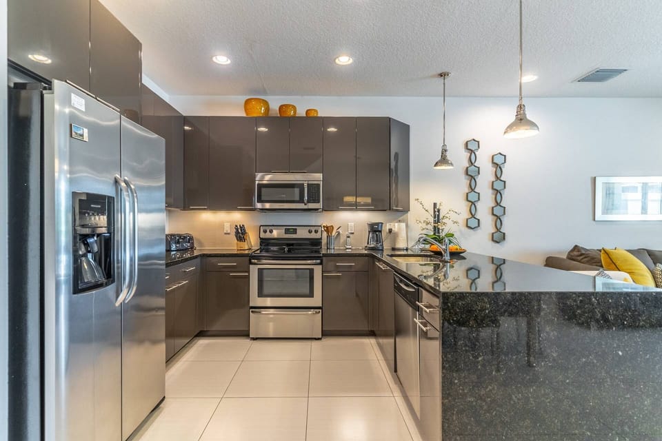 Modern Kitchen w/Stainless Steel appliances and waterfall granite countertops
