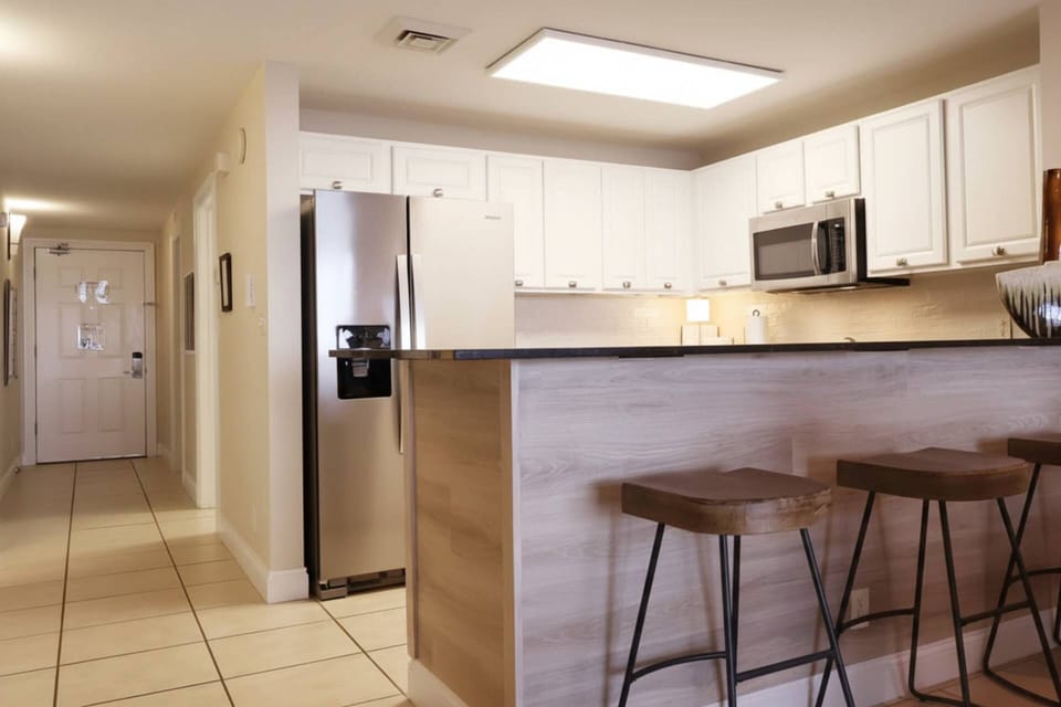 Bright open kitchen allows for engagement even when preparing meals and seating for 3 at the bar.