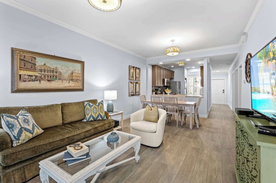 Living Room with Brand New Furniture and Flat Screen HDTV; Entrance to Lanai Area with Golf and Lake Views; Totally Redecorated! Couch is a Pullout!