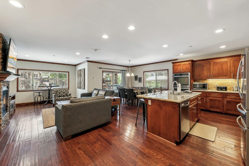 Spacious open-plan living with gleaming hardwood floors, granite counters, and rich cherry cabinets creates your perfect gathering space.