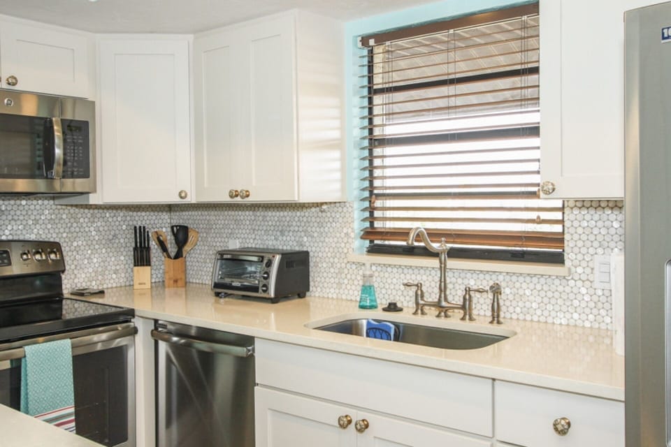 Plenty of space to work in this newly remodeled kitchen w/stainless steel appliances & stackable washer/dryer in entry area closet.