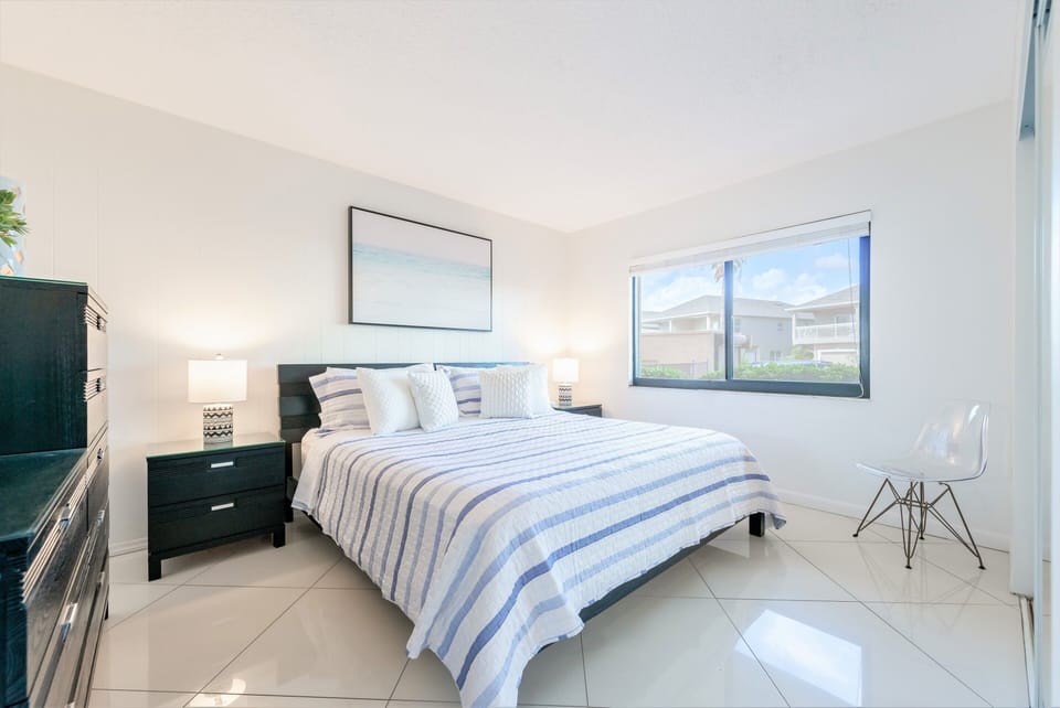 Guest bedroom retreat with a plush king bed and plenty of natural light.
