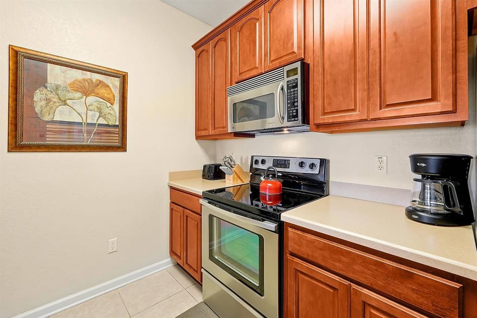 Fully Stocked kitchen with electric stove and drip coffee maker
