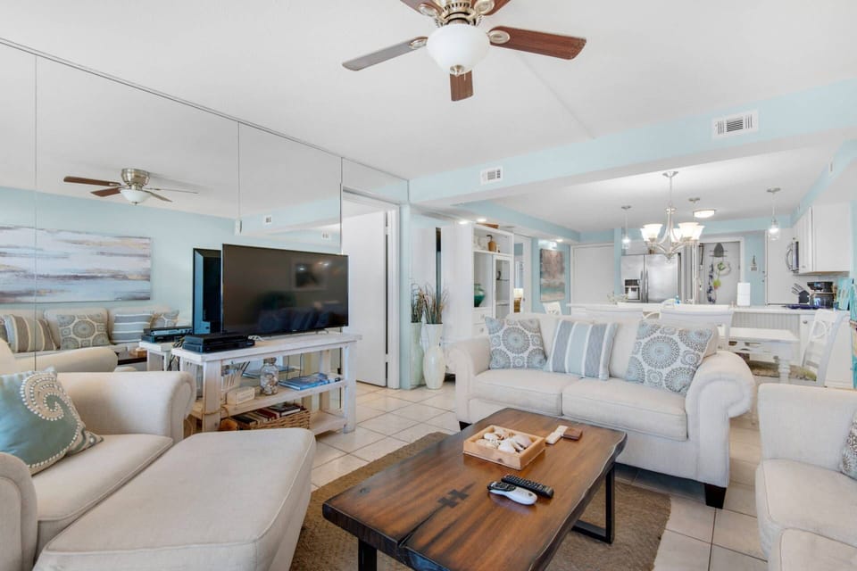 The living room has cozy couches and a large flat-screen T.V. to relax at the end of the day.