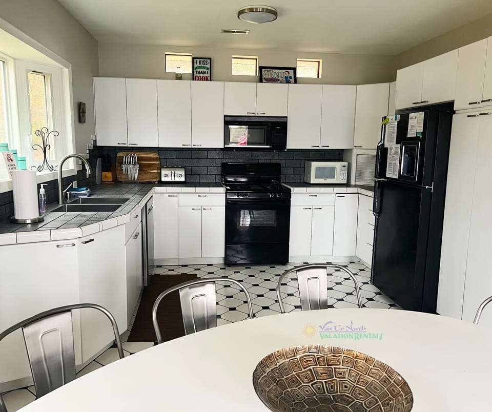 Kitchen and dining area with access to back deck. - Kitchen and dining area with access to back deck.