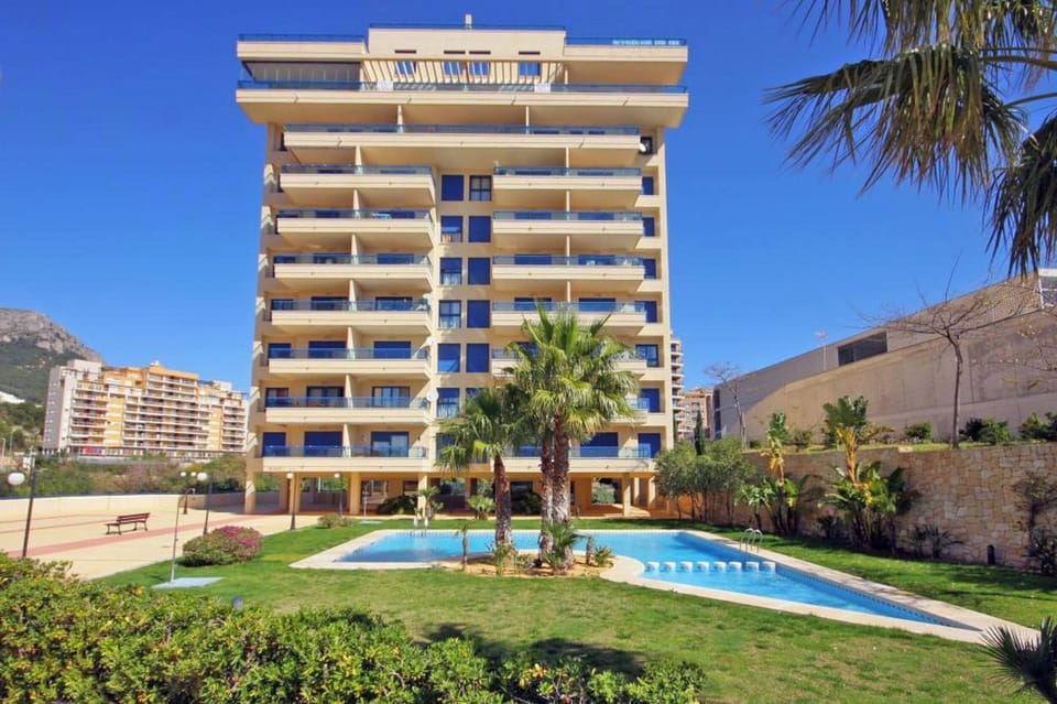 We are pleased to present you our beautiful holiday apartment with communal pool in Calpe, Costa Blanca. This apartment sleeps 4 people and has two bedrooms and two bathrooms.Inside the apartment, you will find a spacious living-dining room with TDT/SAT TV, air conditioning and access to the terrace. The kitchen is independent and fully equipped with a ceramic hob and dishwasher. The two bedrooms have a double bed each and also have air conditioning. One of the bedrooms has an en-suite bathroom with a bathtub. In addition, there is another bathroom with a shower.Outside, the apartment offers a pleasant area with a communal pool, Roman steps and outdoor shower, perfect for cooling off on hot summer days. There is also a tennis court available to guests, as well as a parking space for one vehicle.The location of the apartment is privileged, since it is close to the sea and all services. The nearest rock cove is just 750 meters away, and the restaurants and center of Calpe are 900 meters away. Furthermore, the nearest supermarket is just 350 meters from the apartment.Importantly, we offer free WiFi so you can stay connected during your stay. In addition, pets up to 12 kg are allowed with an additional fee.We hope you enjoy your stay in our beautiful holiday apartment with communal pool in Calpe. If you have any additional questions or need more information, do not hesitate to contact us.