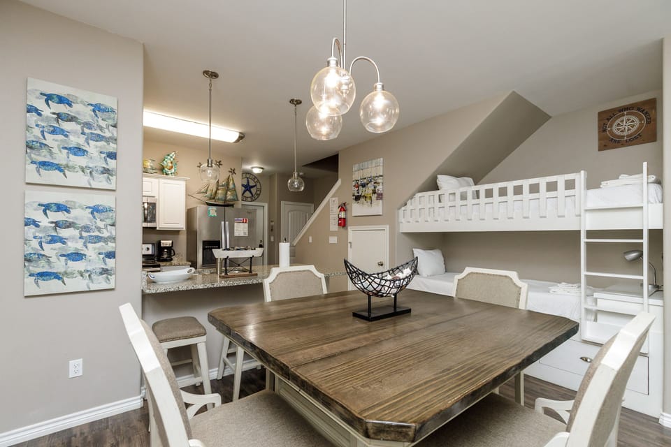 Your spacious dining area flows seamlessly into the kitchen, with charming nautical touches and bunk beds perfect for family gatherings.