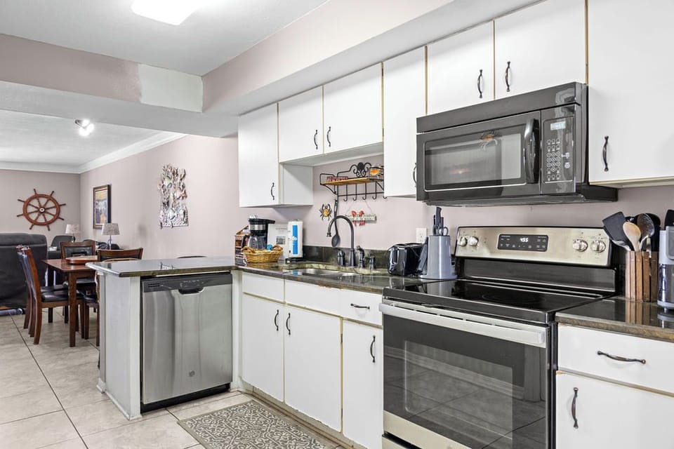 Kitchen - The spacious kitchen features black and stainless appliances and is fully stocked with all items needed for preparing meals during your stay.