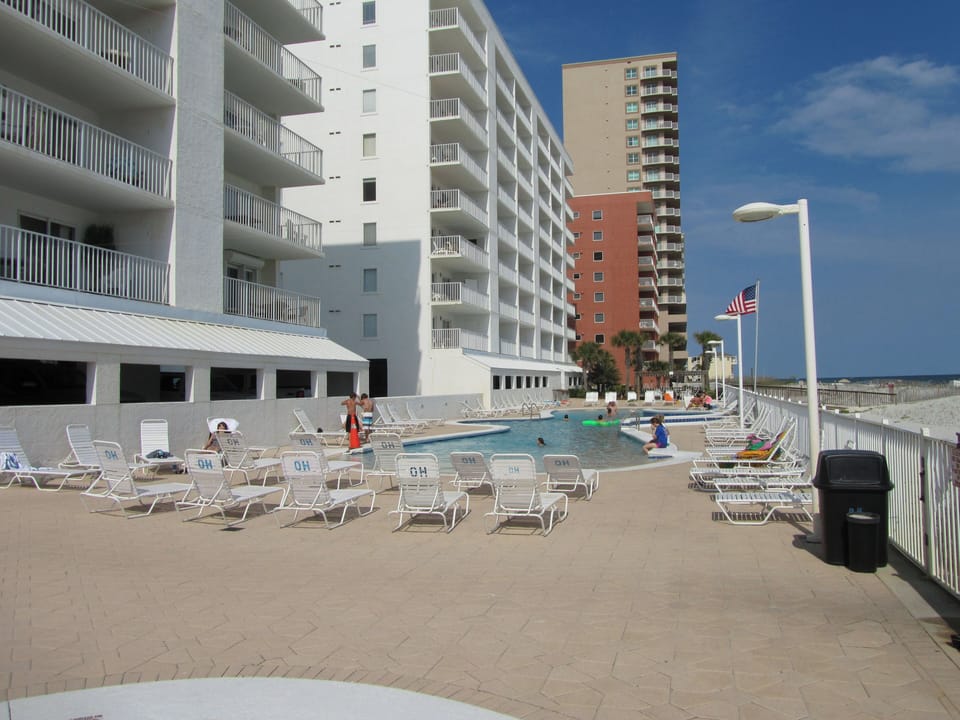 Outdoor Communal Pool - The zero entry pool features plenty of loungers for enjoying a relaxing day in the sun.
