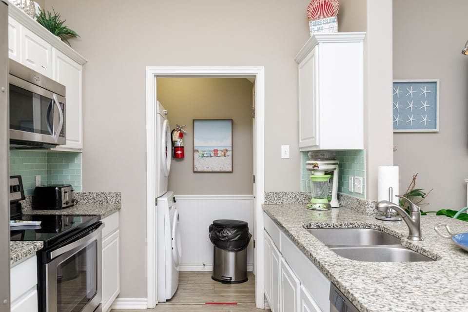 Your fully equipped kitchen features granite counters, stainless appliances, and connecting laundry room for ultimate convenience.