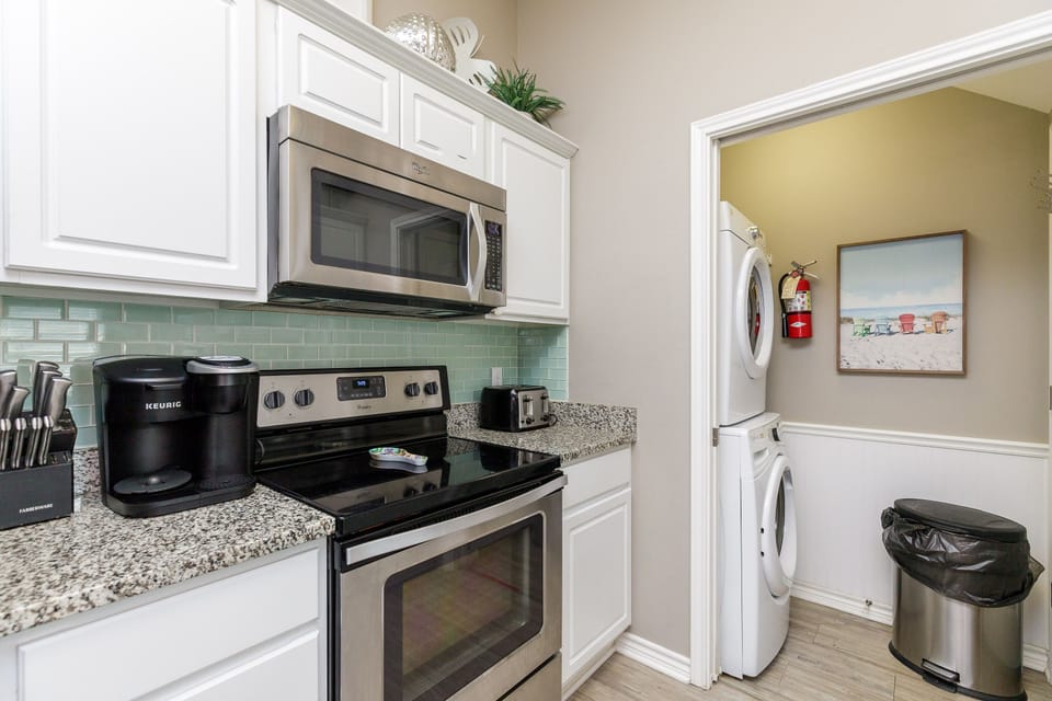 Your fully equipped kitchen features modern appliances and granite countertops, with convenient laundry access right next door.