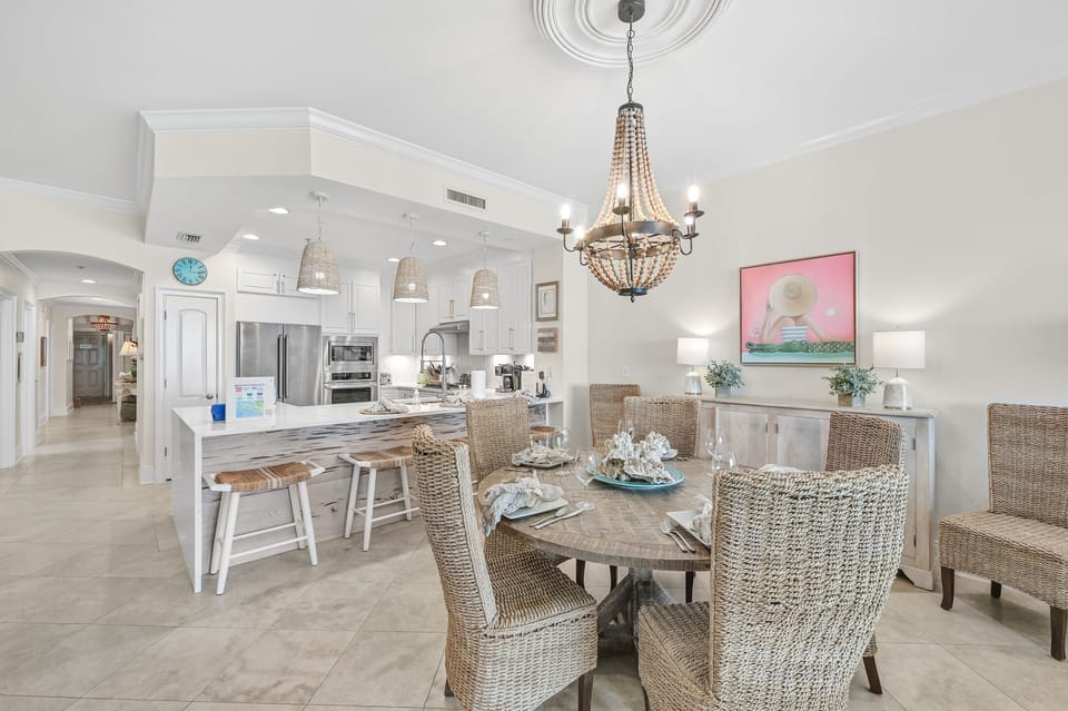 Dining area with new round table. - Extra chairs provide seating for 7 at the table and four at the kitchen counter. Beautiful new cypress kickboard under counter top.