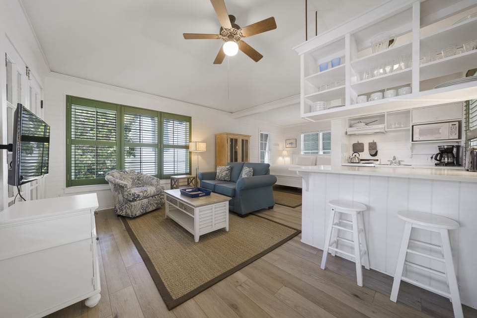 VIEW OF LIVING AREA AND BAR SEATING FOR TWO