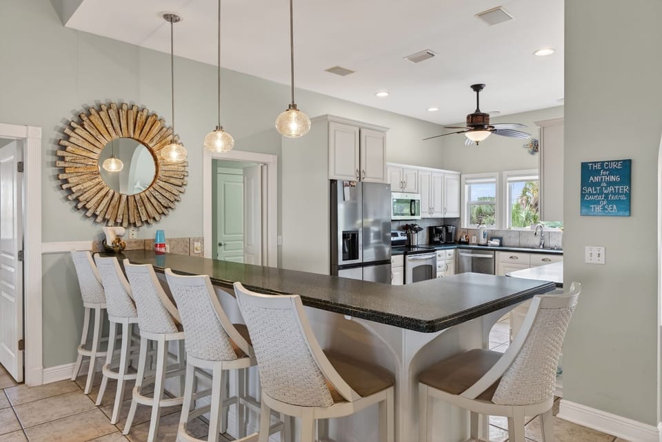 Gather around your spacious breakfast bar where stylish pendant lights create the perfect ambiance for morning coffee or evening cocktails.