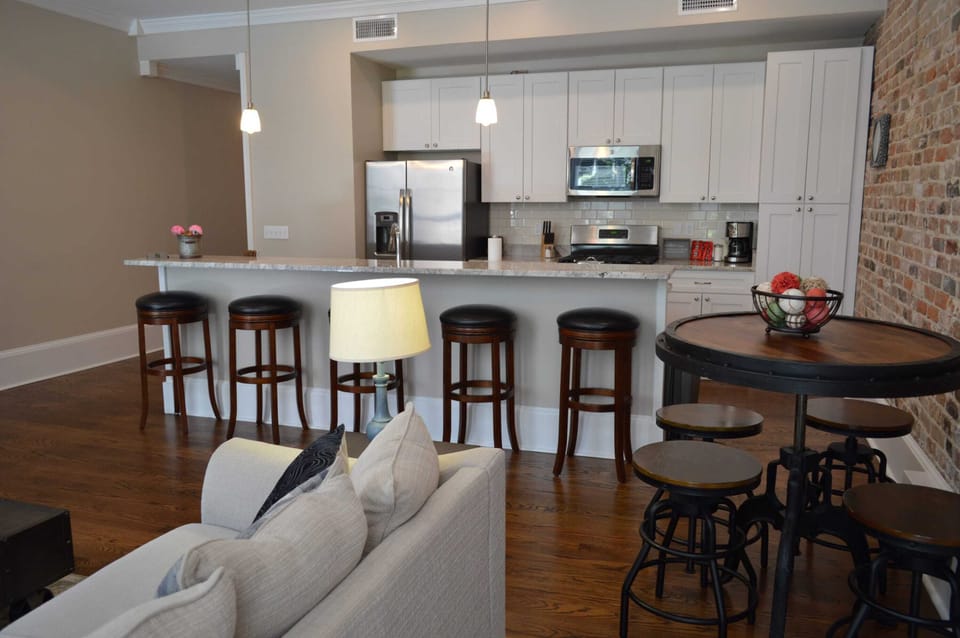 Large space has breakfast bar and adjustable stools in this Business and Industry themed condo