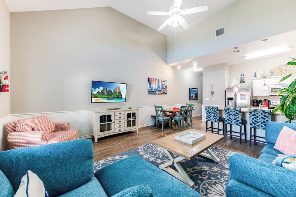 The kitchen, dining, and living areas blend seamlessly for a bright and airy feel