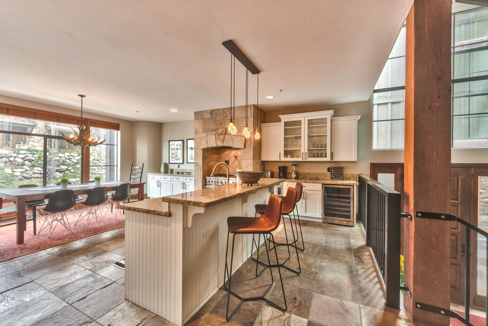 Fully Equipped Gourmet Kitchen with Island Seating and Wine Fridge