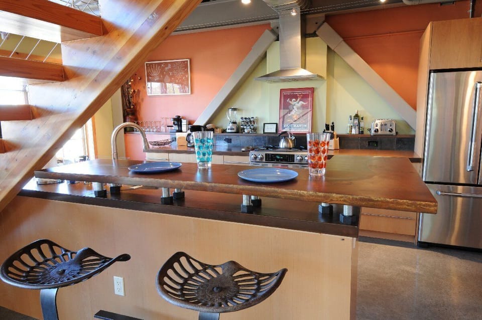 There is a bar counter for chatting with the cook, and the dining table is just off to the side.