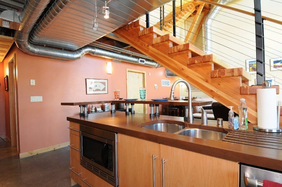 A view into the dining and living area from the kitchen sink.