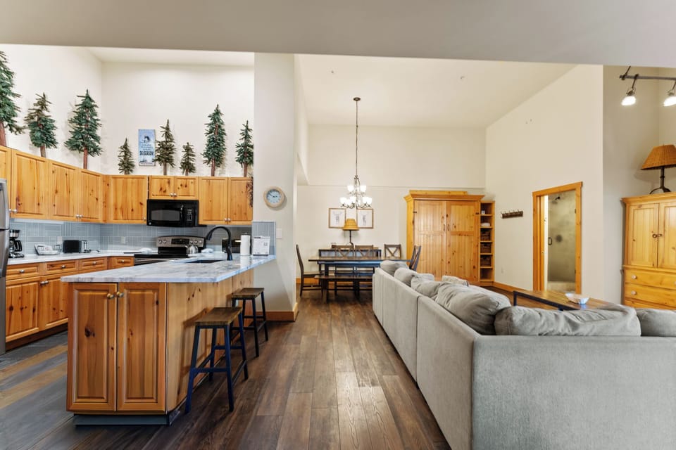 Step into your cozy mountain retreat where rustic charm meets comfort—featuring a fully equipped kitchen and open living space.