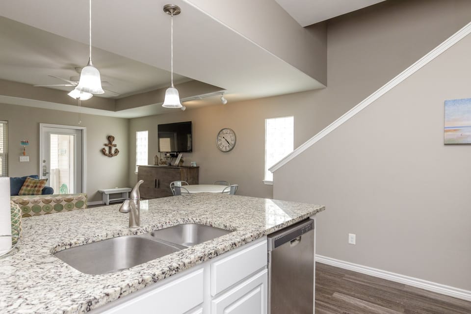 Your open kitchen island flows into the living area, perfect for morning coffee or entertaining guests in this bright, modern space.