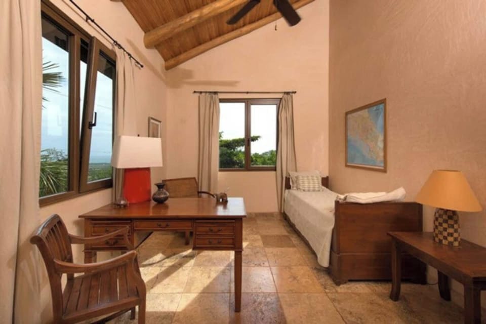 Versatile room with a single bed and a charming office desk, perfect for a comfortable stay or a productive workspace during your Tamarindo vacation.