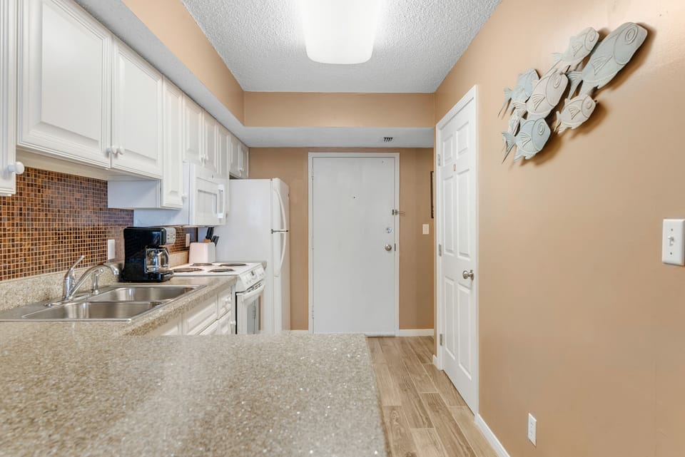 Kitchen - The kitchen offers a large pantry and eat in bar and is fully stocked with all items needed for meal prepping.