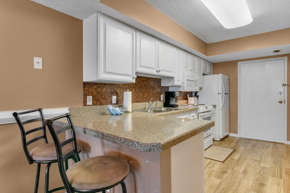 Kitchen - The spacious kitchen offers an eat in bar with seating for 2.