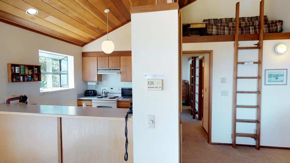 The Master bedroom is located just off the kitchen.  The upper loft is off limits for guests and is used for owner storage only.