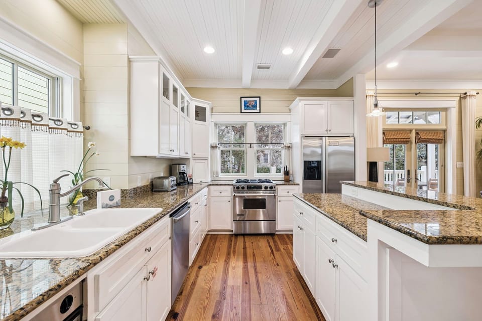 Step into your gourmet kitchen with granite counters, stainless appliances, and warm wood floors—perfect for creating memorable meals together.