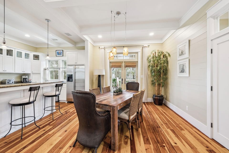 Gather around this beautiful open dining space where gleaming hardwood floors and elegant pendant lighting create the perfect atmosphere for memorable meals together.