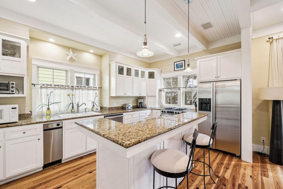 Your gourmet kitchen features granite countertops, stainless steel appliances, and a spacious island perfect for cooking and entertaining.