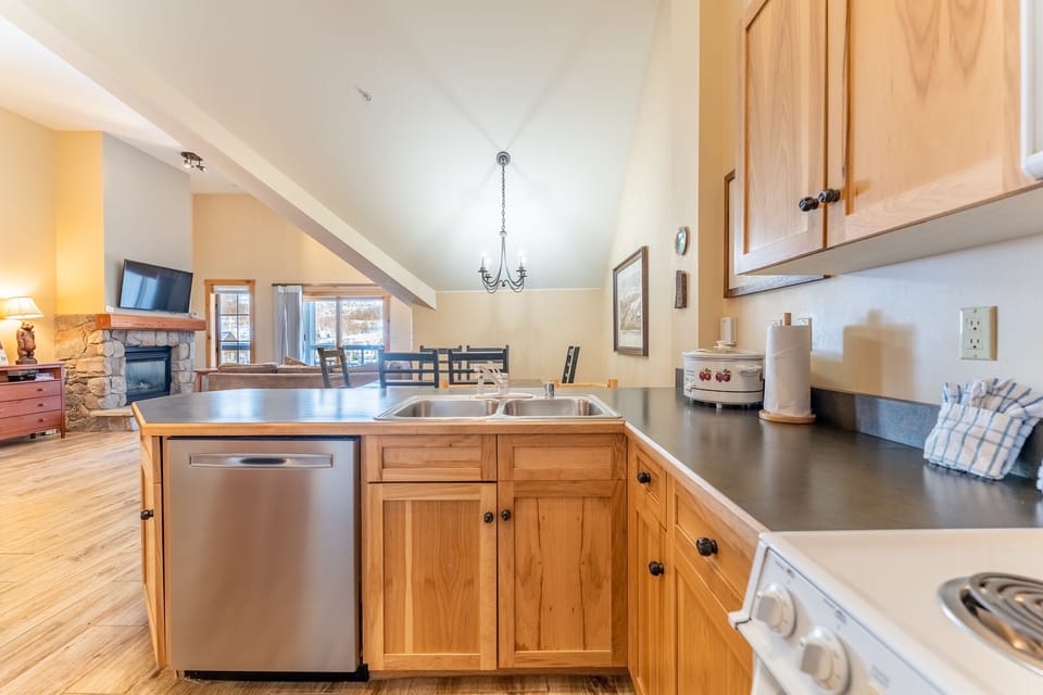 Full size kitchen with vaulted ceilings and hardwood flooring.
