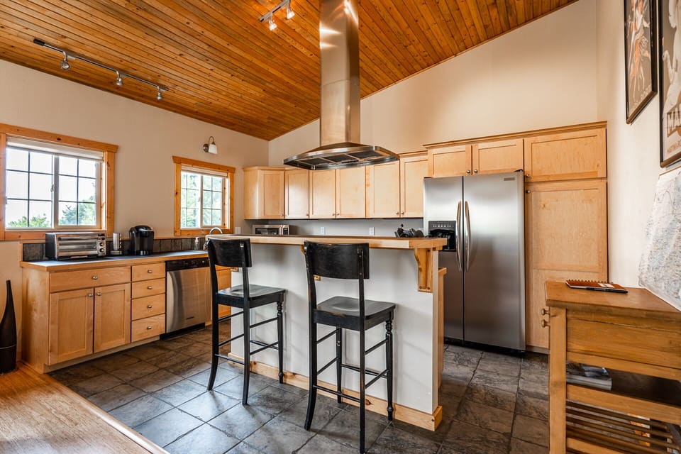 Full kitchen with two bar seats at the island.