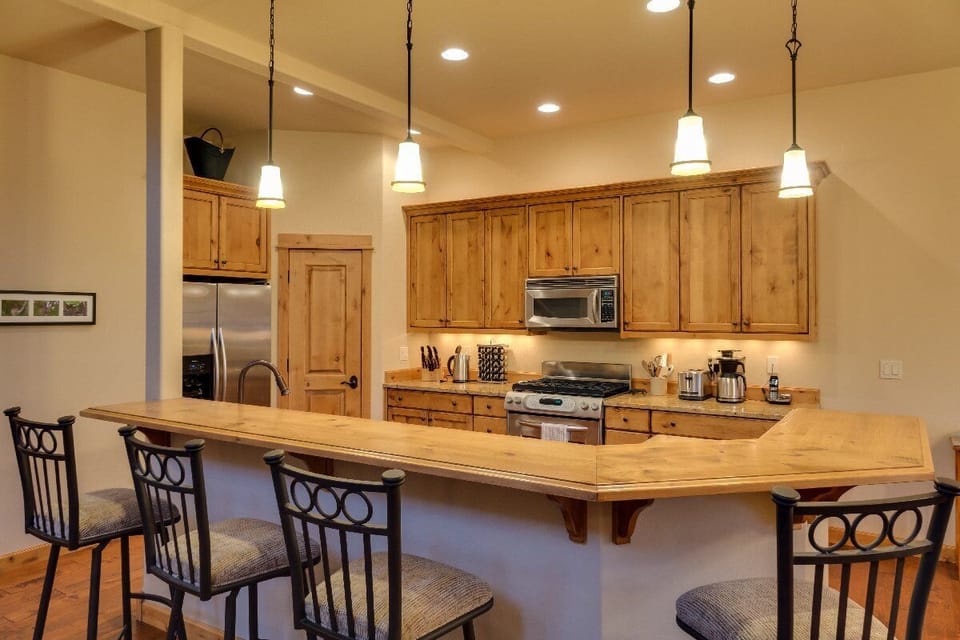 In addition to the dining room table there is a breakfast bar.