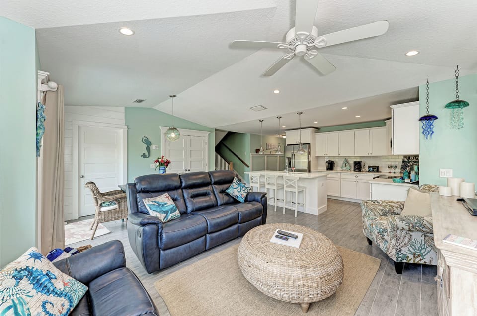 High vaulted ceilings and large sliders give the living room a lite, bright, airy feel