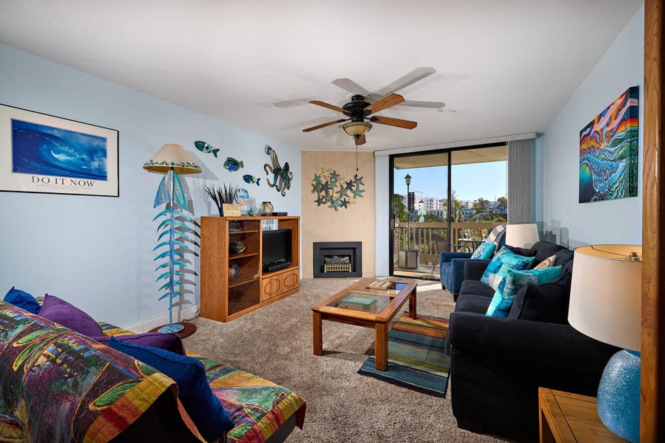 living room- sleeper sofa and futon with electric fireplace, ceiling fan