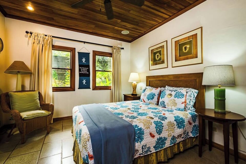 Relax in this cozy guest room with a queen-size bed, bright natural light, and a peaceful retreat after a day enjoying Costa Rica’s sun and surf.