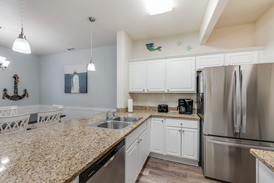 Your modern kitchen awaits with gleaming granite counters, stainless appliances, and coastal charm for memorable meal prep.