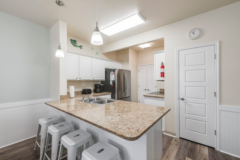 Your modern kitchen awaits with granite counters, stainless appliances, and bright skylights creating the perfect space for morning coffee or evening meals.