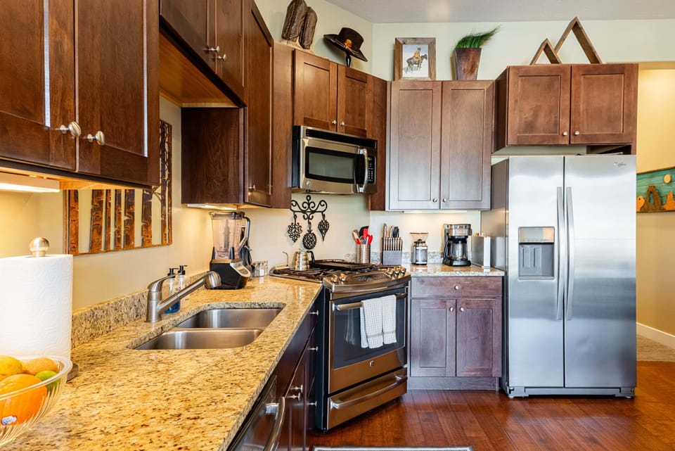 Fully equipped kitchen with granite counters and stainless appliances.