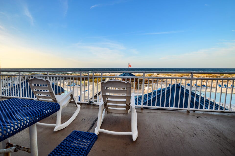 Common Area Deck in Sugar Beach Complex - Sit down, relax and put your feet up! You are now on vacation and Sugar Beach is a great spot to do it. Endless views of the Gulf from this spot and several other locations throughout the complex.