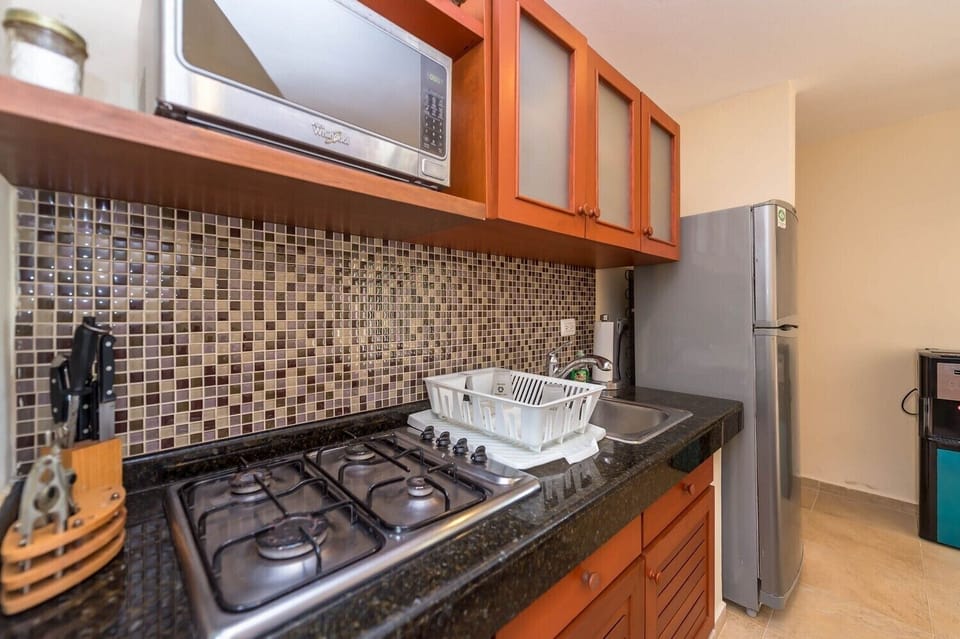 Kitchen area with microwave and stove top - Studio 001 Aventuras Akumal beach vacation rental