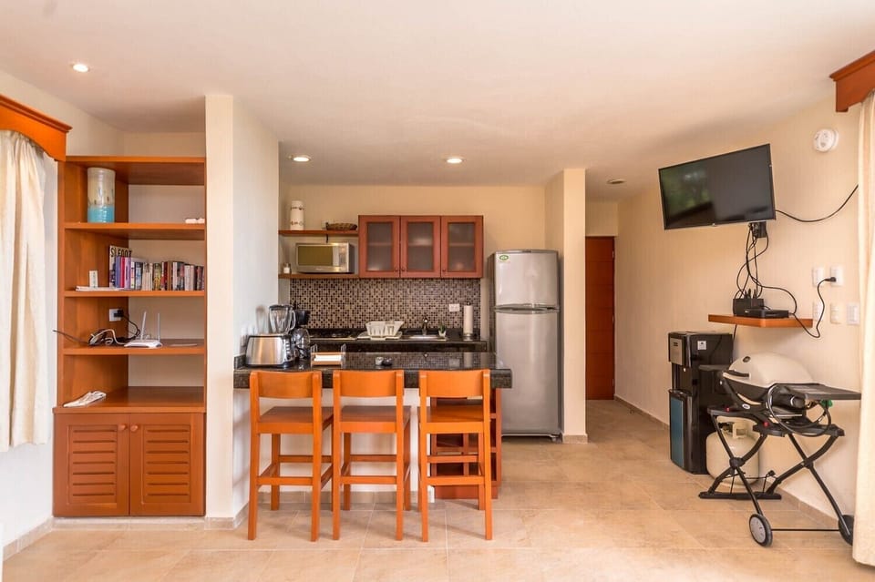 Kitchen area with SAT TV and Portable Grill - Studio 001 Aventuras Akumal beach vacation rental